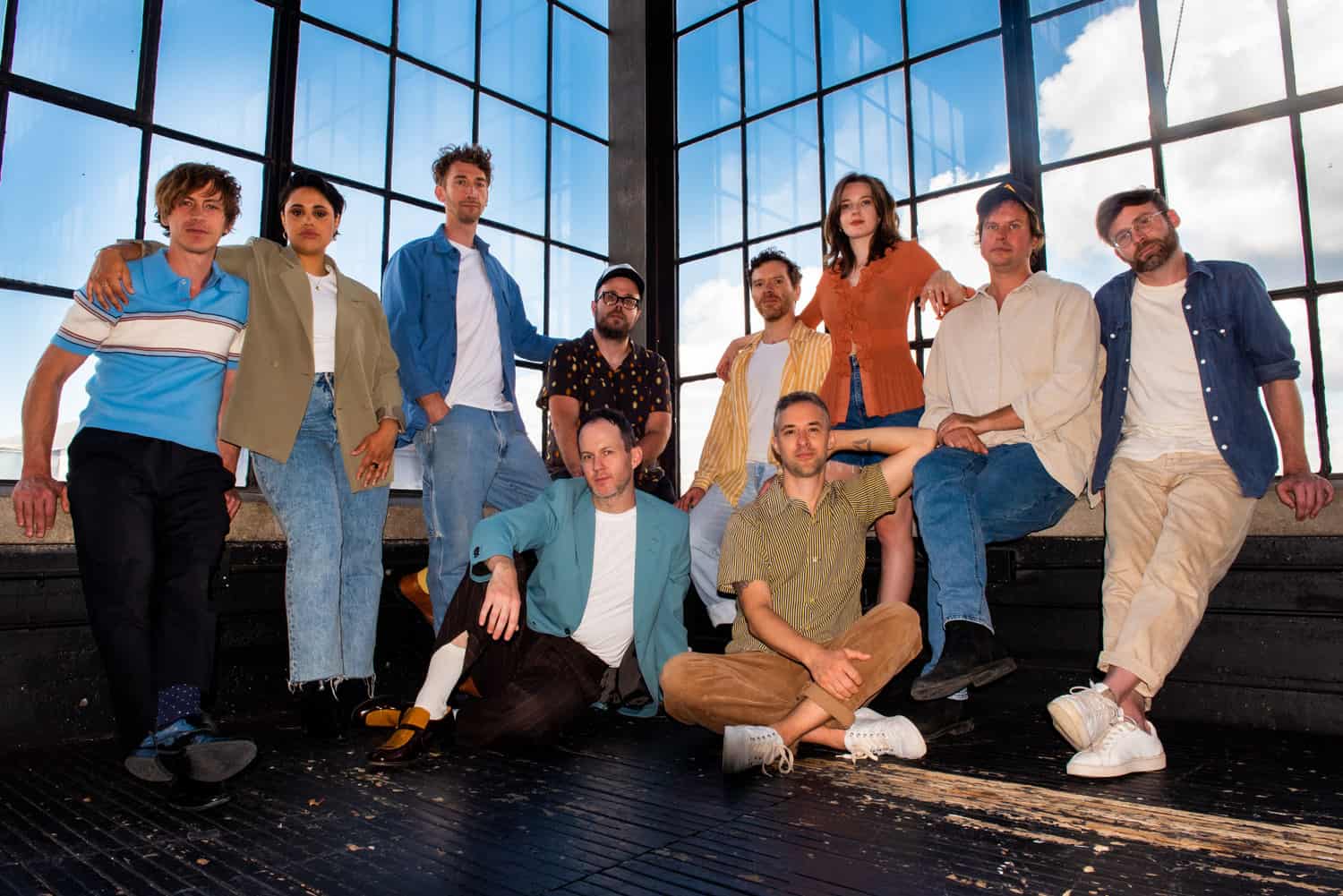 Band portrait with 10 band members in front of large window